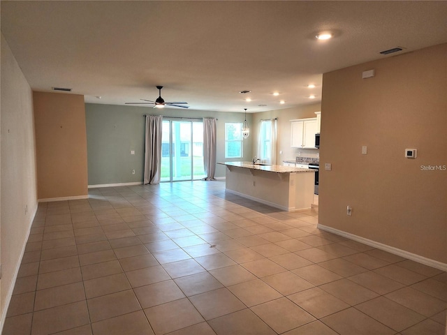 unfurnished living room featuring ceiling fan, recessed lighting, baseboards, light tile patterned floors, and visible vents