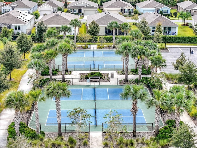 view of sport court with fence and a residential view