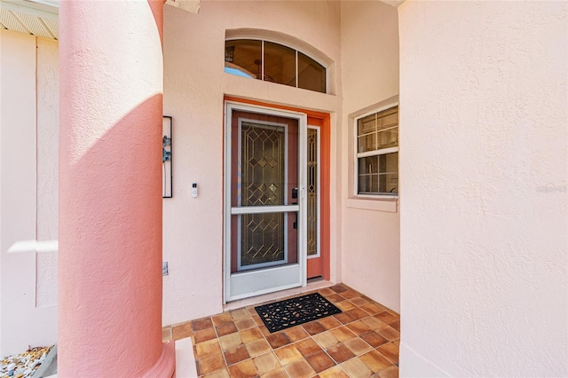 entrance to property featuring stucco siding