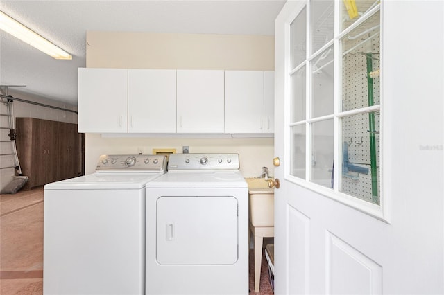 washroom with washer and dryer and cabinet space