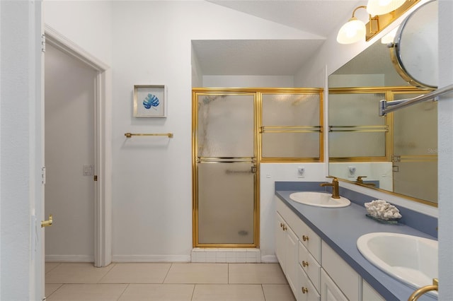 bathroom with a sink, tile patterned floors, a shower stall, and double vanity