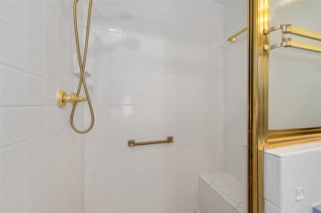 bathroom with a tile shower