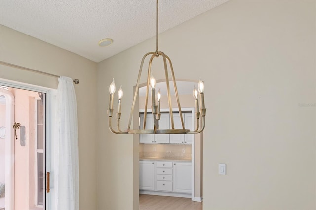interior details with a textured ceiling and wood finished floors