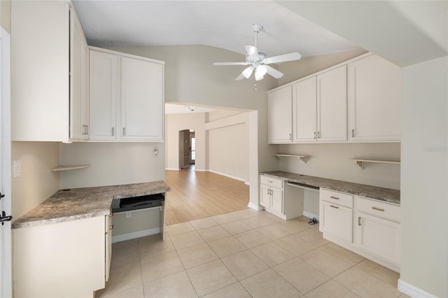 kitchen featuring light tile patterned floors, white cabinets, a ceiling fan, and lofted ceiling