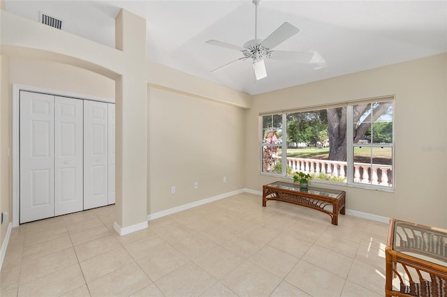 bedroom with a ceiling fan, visible vents, baseboards, a closet, and light tile patterned flooring