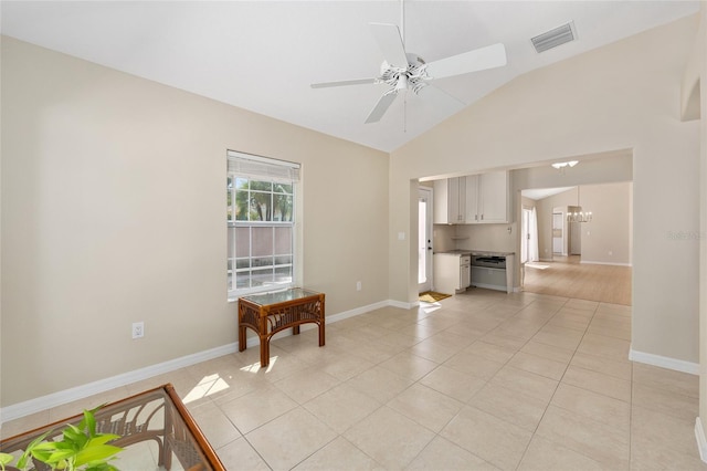 unfurnished living room featuring visible vents, light tile patterned flooring, baseboards, a ceiling fan, and vaulted ceiling