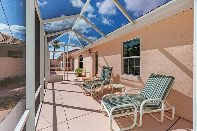 view of patio with glass enclosure