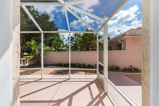 exterior space with glass enclosure and fence