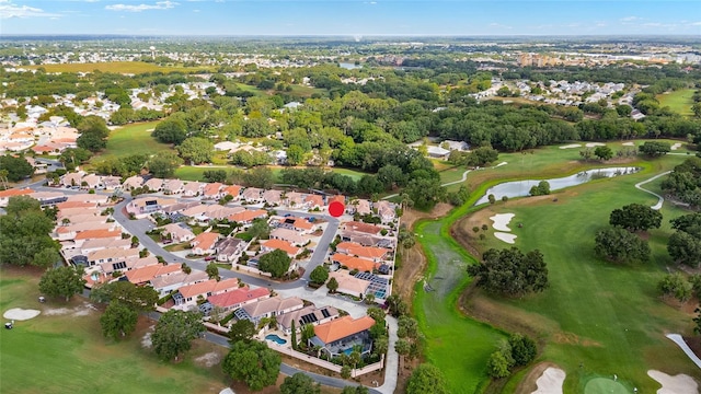 drone / aerial view featuring a residential view, a water view, and golf course view