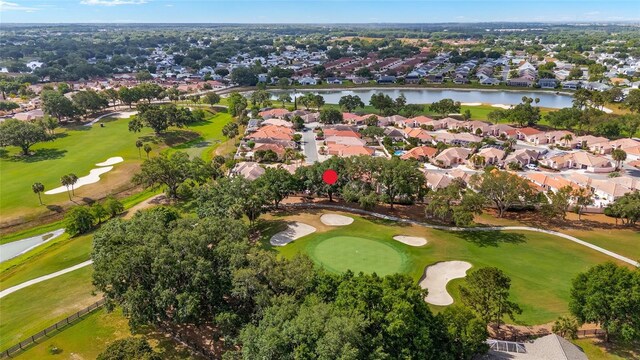birds eye view of property with a water view, view of golf course, and a residential view