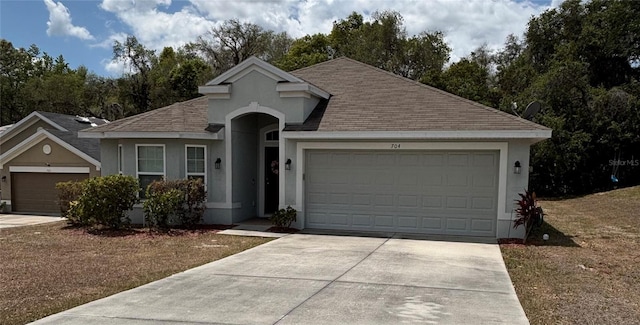 ranch-style home with concrete driveway, a garage, a shingled roof, and stucco siding