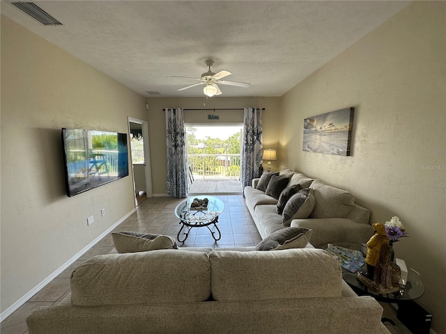 54 SE 910th Ave Unit 210/3, Suwannee, FL 32692 - tiled living area featuring ceiling fan, baseboards, and a textured ceiling