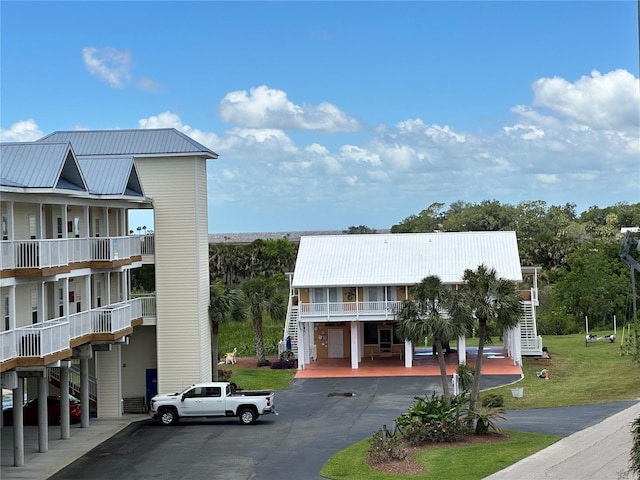 54 SE 910th Ave Unit 210/3, Suwannee, FL 32692 - view of building exterior with stairs, a carport, and driveway