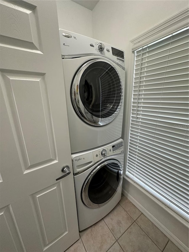 54 SE 910th Ave Unit 210/3, Suwannee, FL 32692 - clothes washing area with stacked washer / dryer and light tile patterned floors