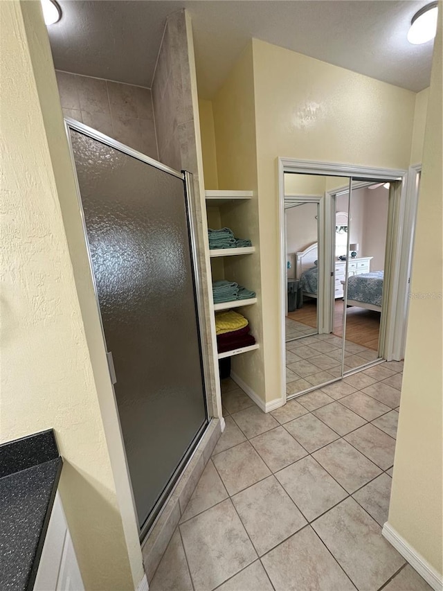 54 SE 910th Ave Unit 210/3, Suwannee, FL 32692 - full bathroom with a stall shower, tile patterned floors, and ensuite bath