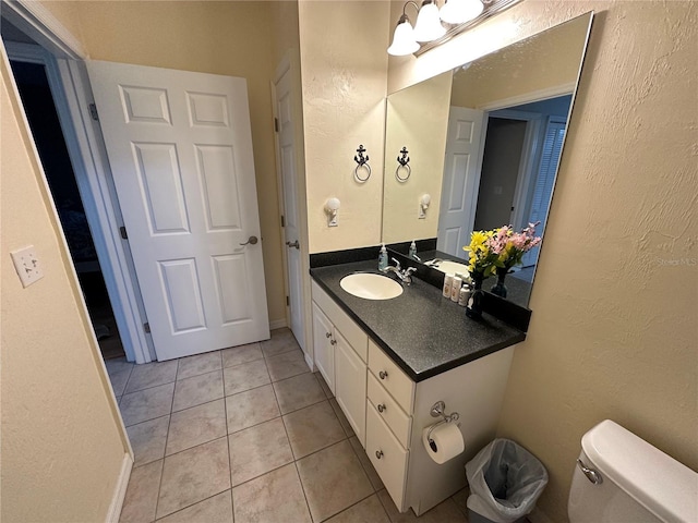 54 SE 910th Ave Unit 210/3, Suwannee, FL 32692 - bathroom with tile patterned flooring, toilet, vanity, and a textured wall