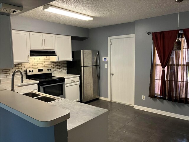 kitchen with white cabinets, light countertops, stainless steel appliances, tasteful backsplash, and under cabinet range hood