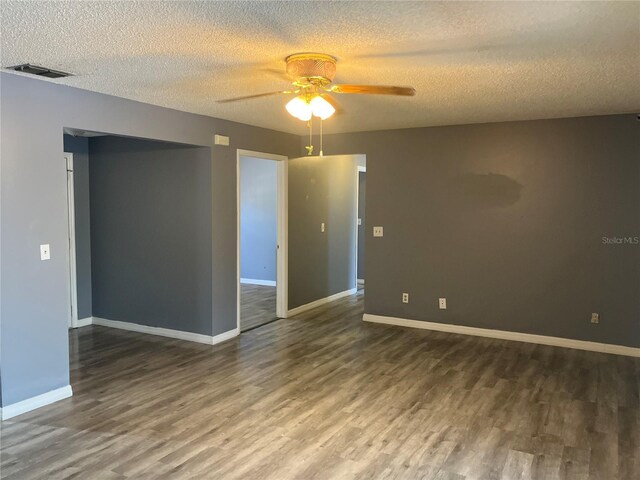 spare room with visible vents, a textured ceiling, ceiling fan, and wood finished floors