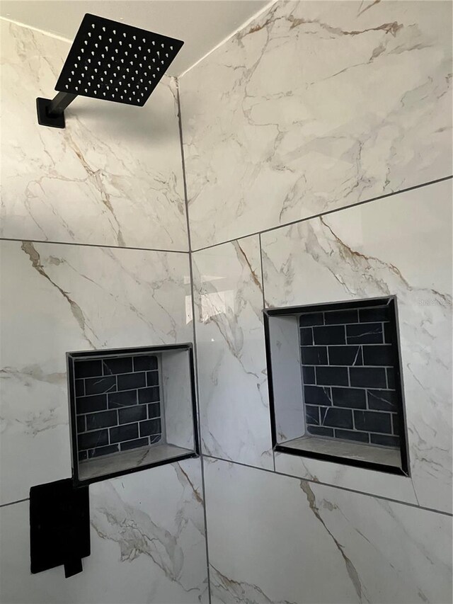 room details featuring a tile shower