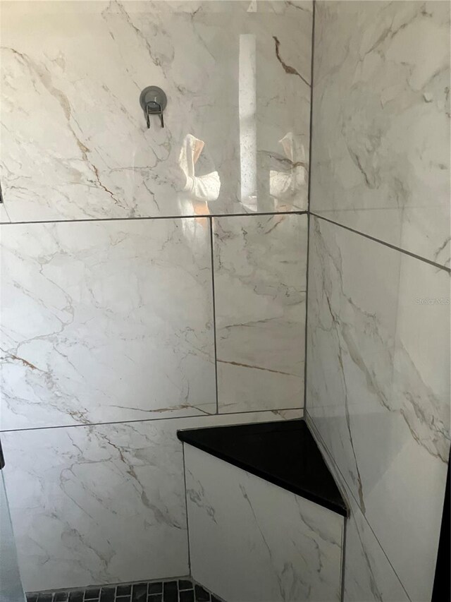 bathroom with a tile shower