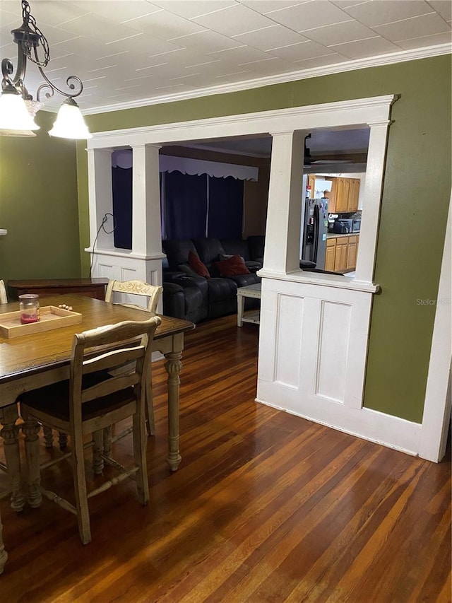 dining room with crown molding and dark wood finished floors