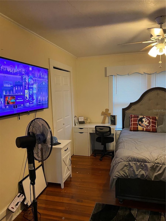 bedroom featuring crown molding, ceiling fan, and dark wood-style floors