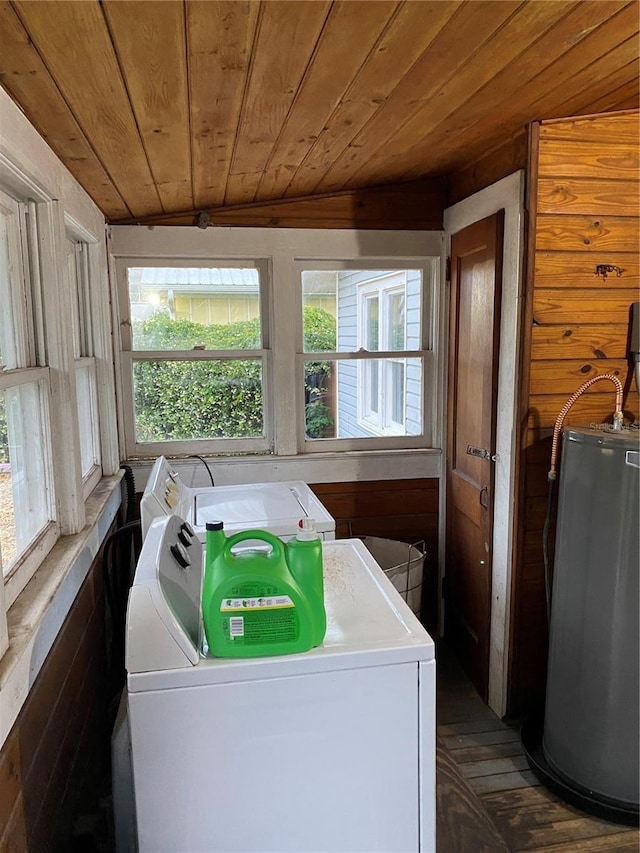 laundry room featuring laundry area, washing machine and dryer, wood finished floors, wooden ceiling, and water heater