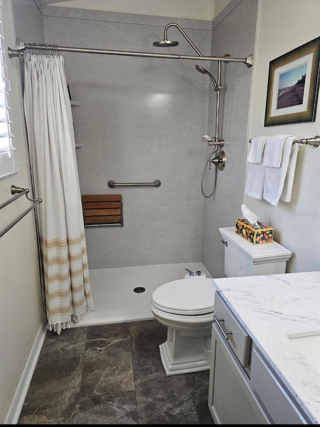 full bath featuring vanity, a shower stall, and toilet