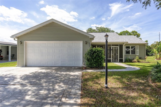 ranch-style home featuring concrete driveway, a shingled roof, and a front yard