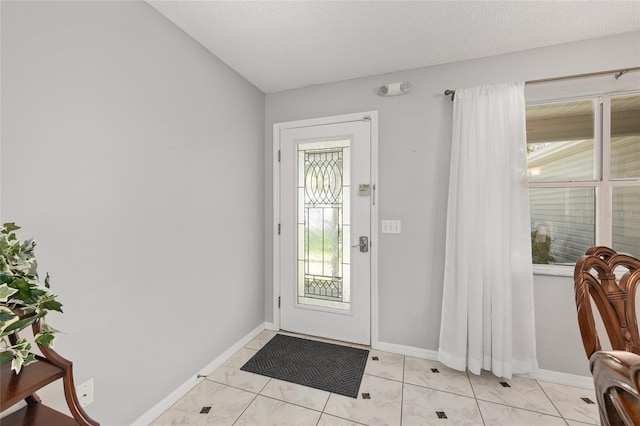 doorway to outside with baseboards and marble finish floor