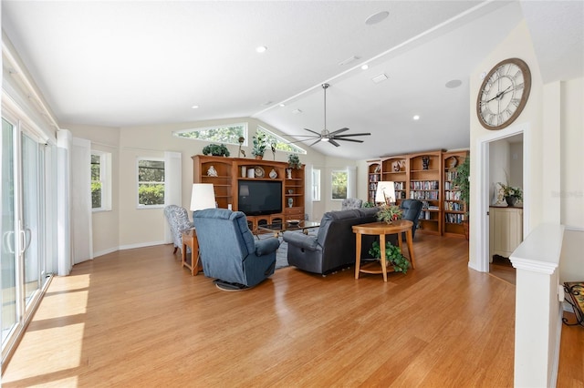 living room featuring ceiling fan, baseboards, lofted ceiling, and light wood-style floors