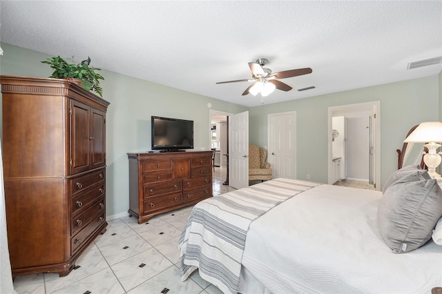 bedroom featuring connected bathroom, a textured ceiling, ceiling fan, and visible vents