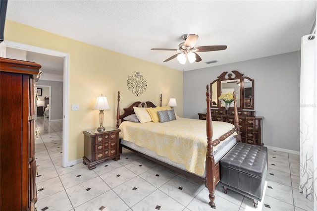 bedroom with baseboards, ceiling fan, visible vents, and light tile patterned floors