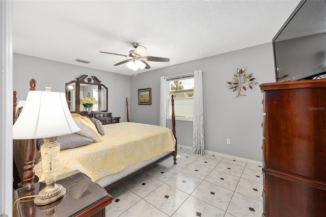 bedroom with baseboards, ceiling fan, and visible vents