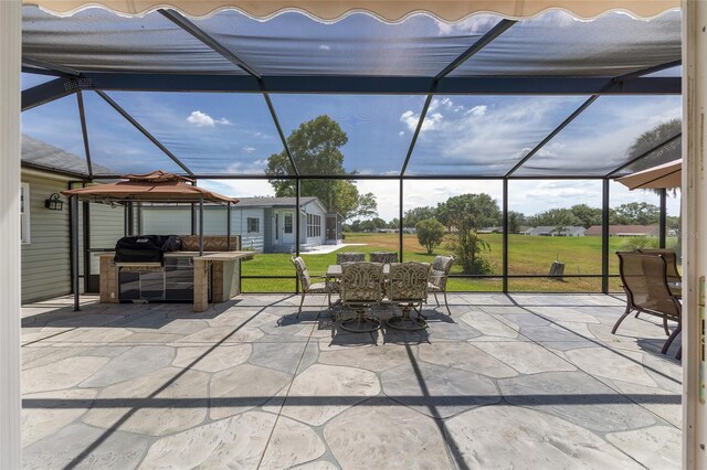 view of patio / terrace with outdoor dining area, area for grilling, exterior kitchen, a gazebo, and a lanai