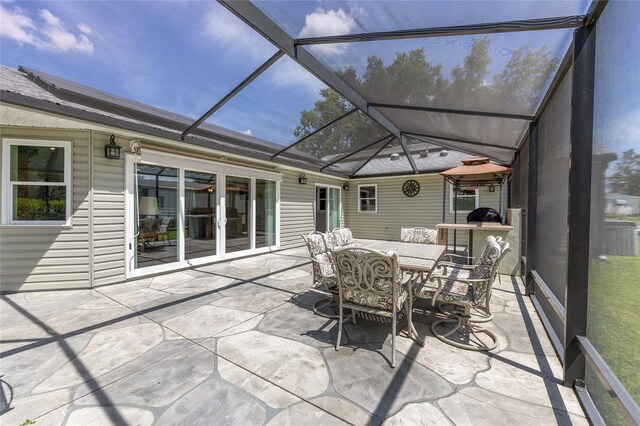 sunroom / solarium with french doors and outdoor dining space