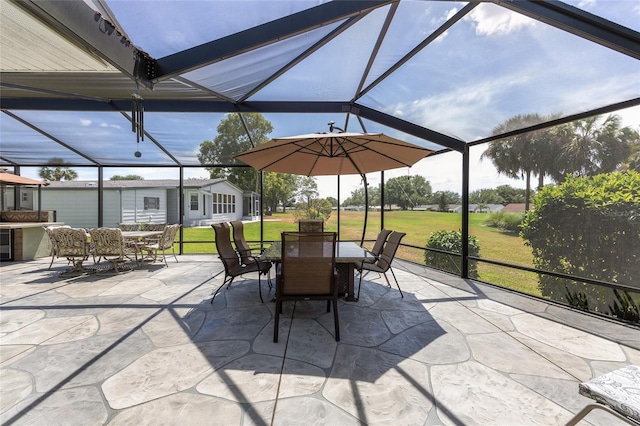 view of patio with glass enclosure and outdoor dining area