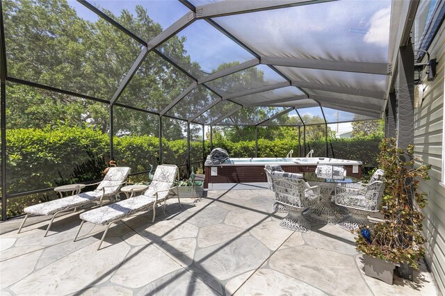 view of patio featuring a hot tub, a lanai, and outdoor dining space