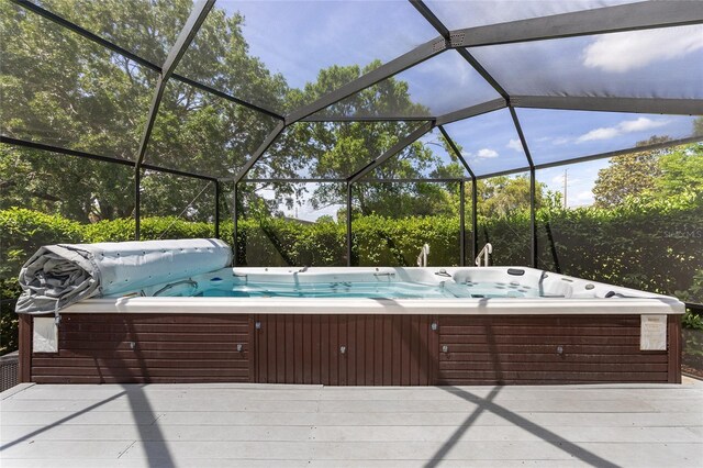 view of patio with a hot tub and a deck