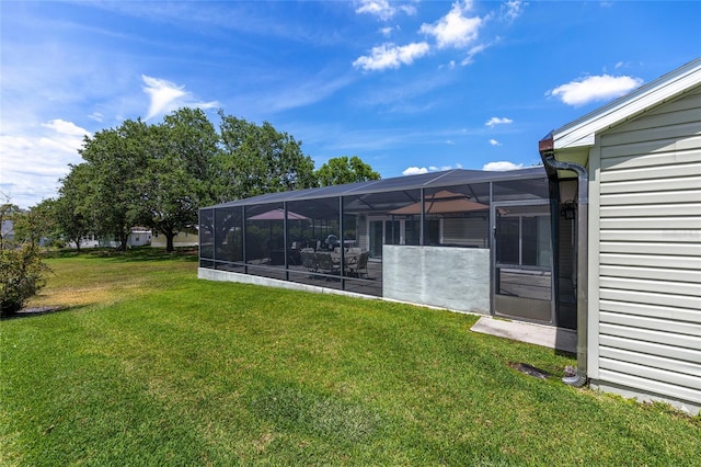 view of yard with glass enclosure