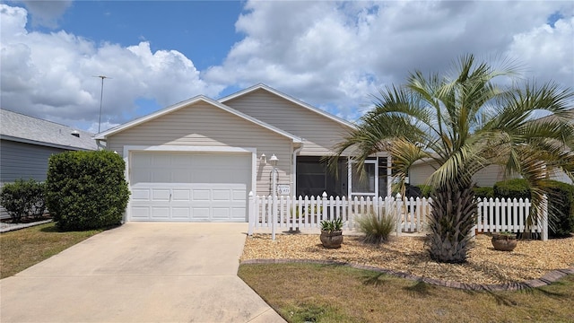 view of front of property with fence, an attached garage, and driveway