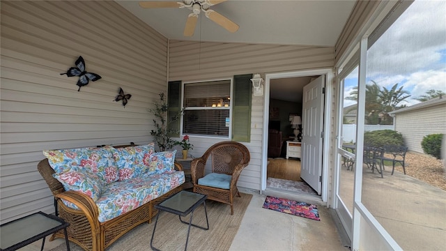 sunroom / solarium featuring a ceiling fan