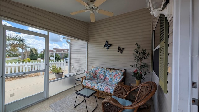 sunroom / solarium with a ceiling fan