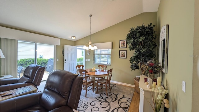 dining area with baseboards, a notable chandelier, and lofted ceiling