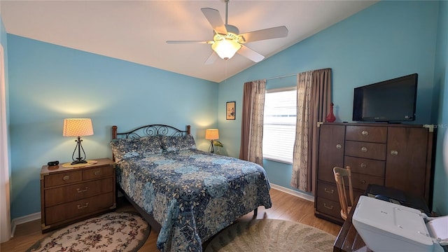 bedroom featuring ceiling fan, baseboards, vaulted ceiling, and wood finished floors