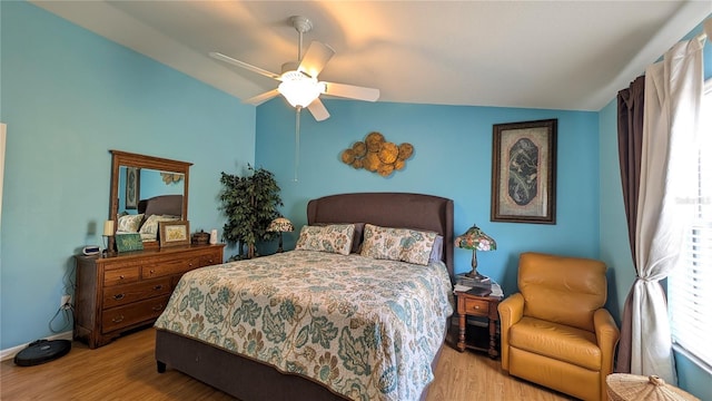 bedroom featuring ceiling fan, wood finished floors, and lofted ceiling
