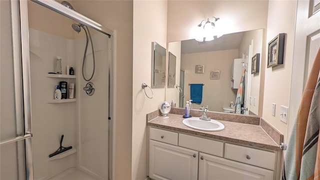 full bathroom featuring vanity, toilet, and a shower stall