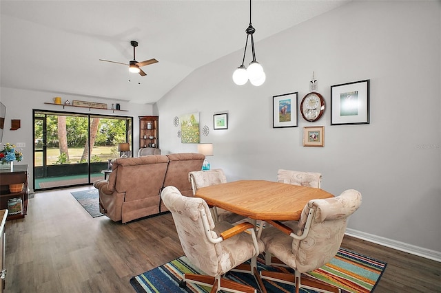 dining area featuring dark wood-style flooring, ceiling fan, vaulted ceiling, and baseboards