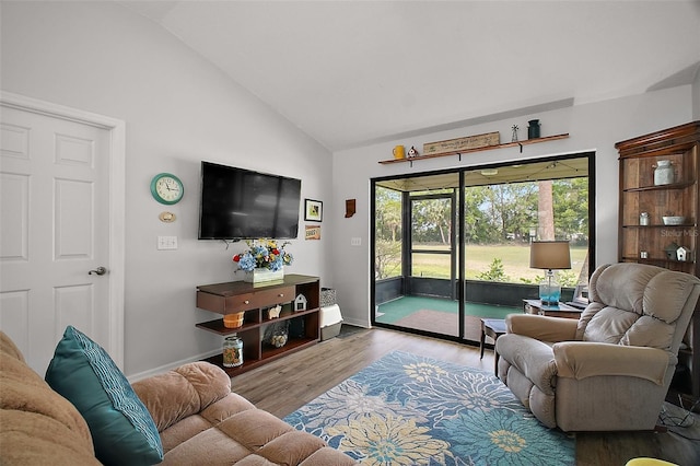 living room with baseboards, high vaulted ceiling, and wood finished floors