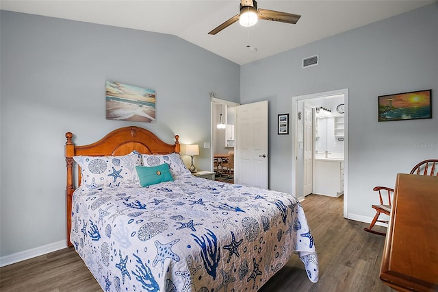 bedroom with baseboards, vaulted ceiling, wood finished floors, and visible vents